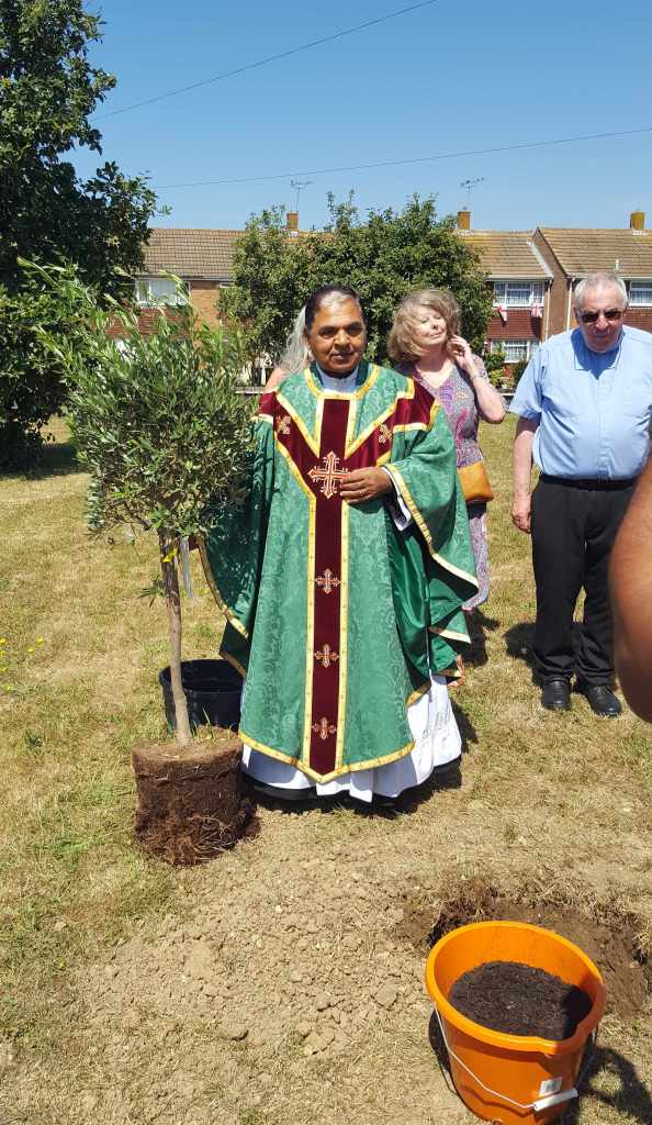 Fr. Jose, parish priest for St. Simon Stock Catholic Church, planting a commemorative tree to mark his 70th birthday